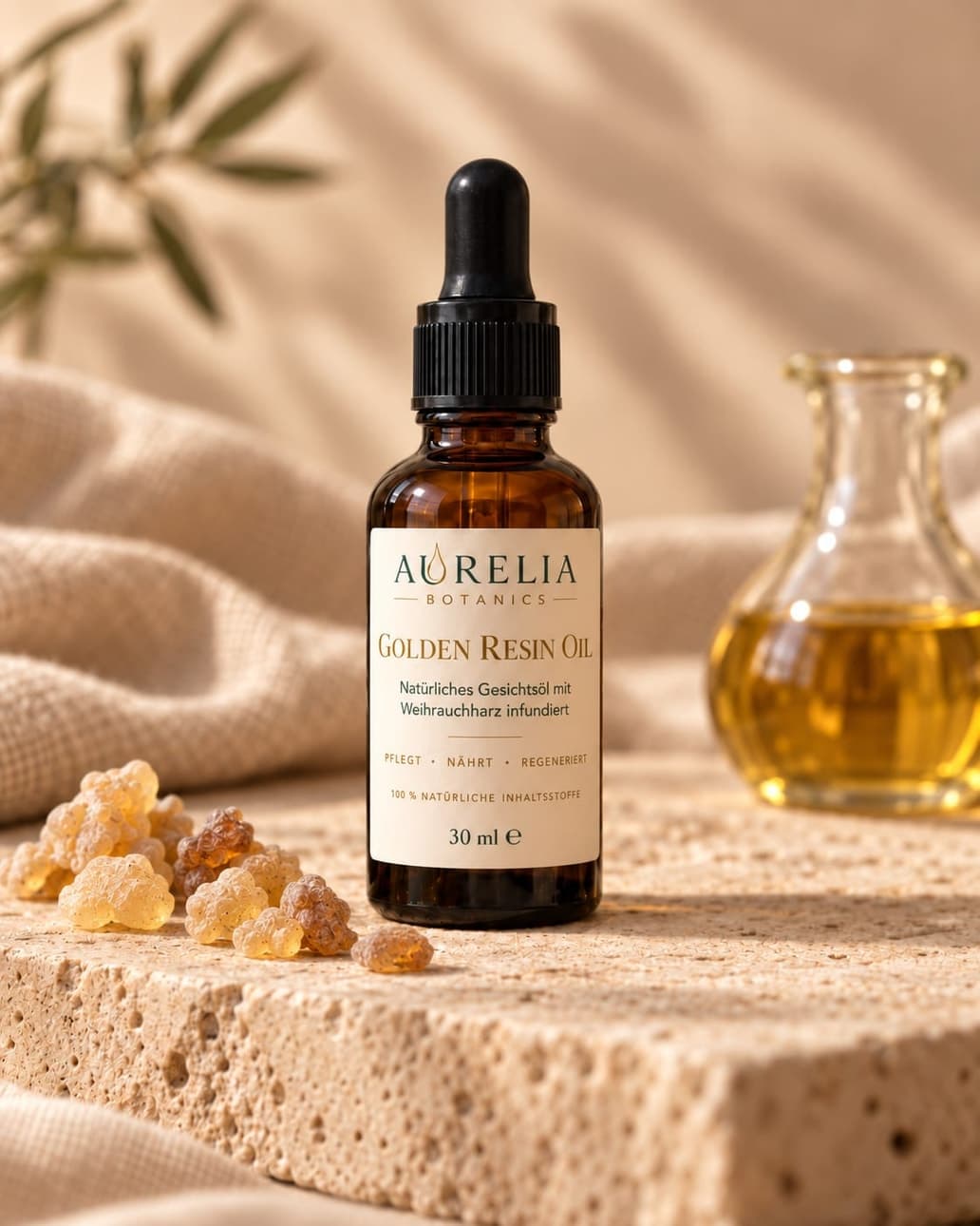 Golden Resin Oil: amber glass bottle with dropper on stone, beside frankincense resin